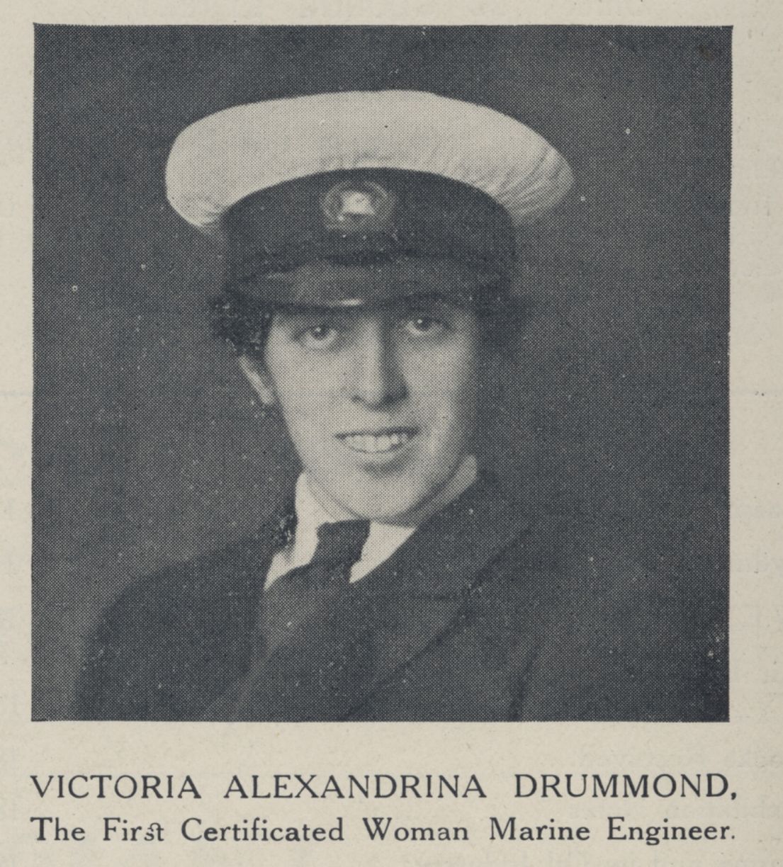 A black and white picture of a women, smiling towards the camera dressed in her Woman's Maritime Engineer uniform.