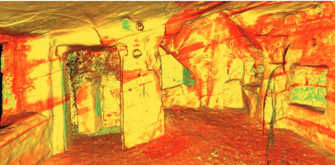 A laser scan of a prehistoric rock room, the end result looks very much like a drawing of a room in yellow, orange and green.